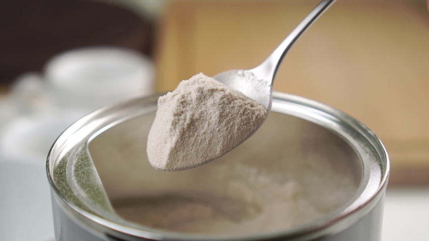 A teaspoonful of psyllium powder over an aluminum can on the kitchen table. Falling husks in slow motion. Close-up. Natural supplements Royalty-Free Stock Footage #1072274822