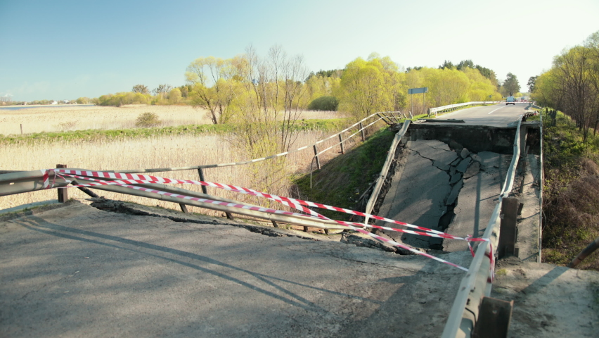 View of the destroyed road bridge as consequences a natural disaster. Large bridge. Destruction of canvas, collapse of the bridge structure.