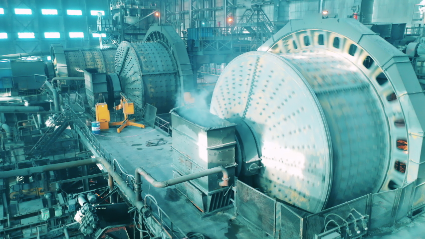 Massive industrial mills are grinding ore at the factory. Mining industrial conveyor at ore processing factory. Royalty-Free Stock Footage #1072281392