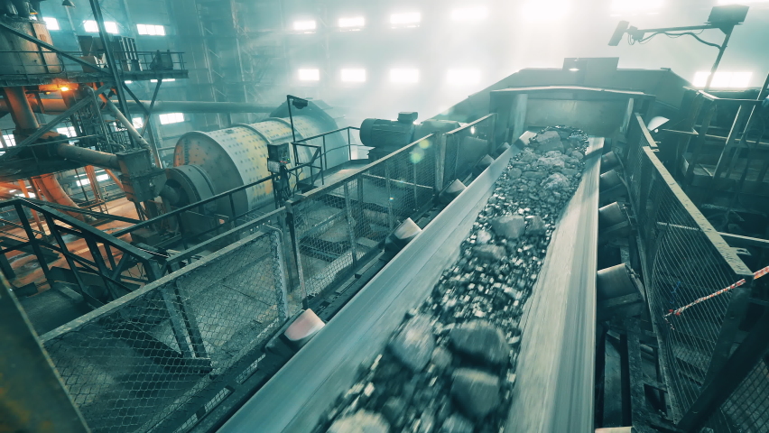 Transportation of copper ore carried out in the factory. Mining industrial conveyor at ore processing factory. Royalty-Free Stock Footage #1072281401