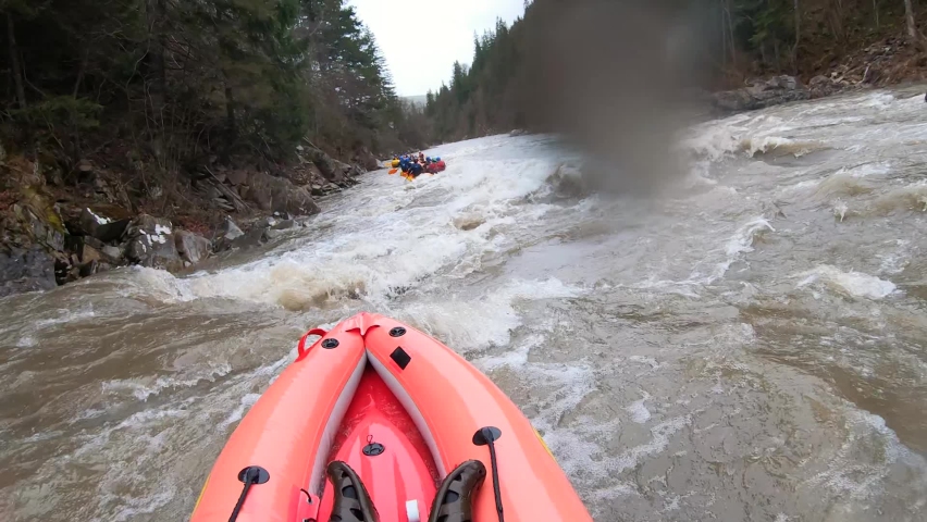 One person rafting on mountain river at spring time. Extreme professional water sport, pov view