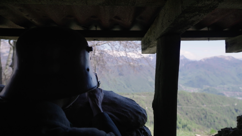 Austro-Hungarian soldiers inside trench aiming outside with landscape view 4K. Filmed with the cooperation of Kulturno zgodovinsko Drustvo Triglav from Slovenia 