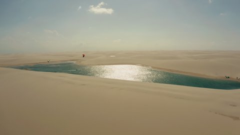 north brazil Lençóis Maranhenses kitesurfer lagoon dunes paradise desert water sports aerial view panorama drone 4k