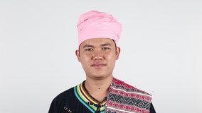 Portrait of young Asian man Tai Lue in Thailand in beautiful costume dress on white background. 
Concept of ethnicity, culture and way of life.