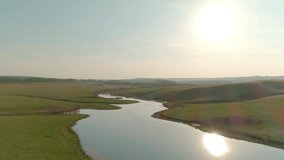 Aerial video of meadow and lake