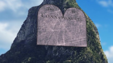 Ten commandments being written on stone in sunny valley pan up