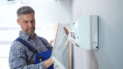 Air Condition Appliance Repair. Technician Or Electrician Cleaning AC