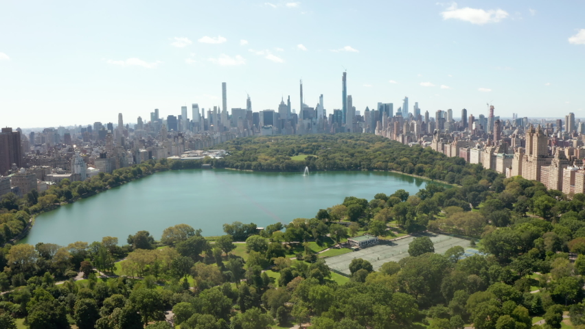 Aerial Drone Flight forward Dolly above Green Central Park in Manhattan, New York City in Summer