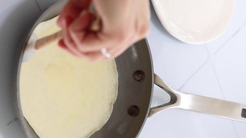 Flipping crepe in hot pan