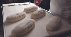 Baker Making Patterns On Raw Bread Using A Knife, slow motion 4k video