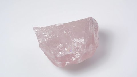 natural rose quartz gemstone on the white turning table