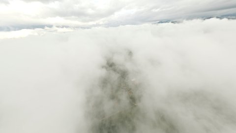 Stunning video of a drone flying at high speed over the clouds. Surfing the clouds, Concept of sky diving, airplane crash.