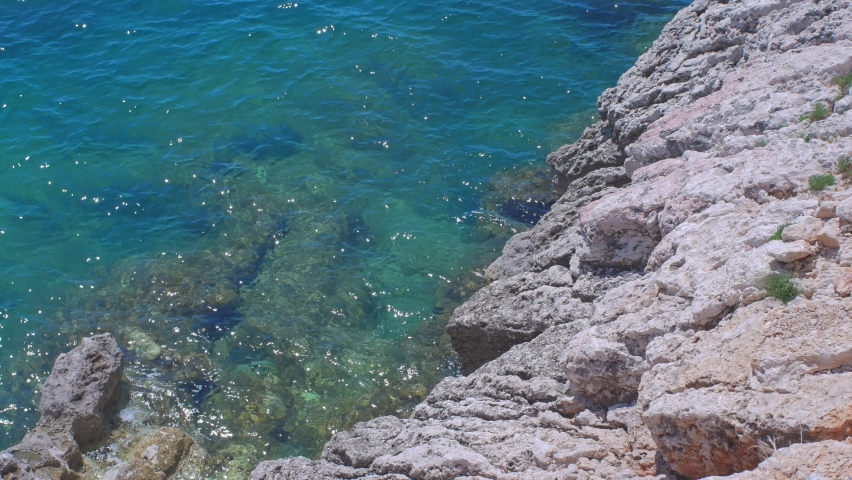 Clear pure water of the Adriatic sea in Montenegro. Rock with sea ladscape. Sunny day in Europe Vacation on the Balkans