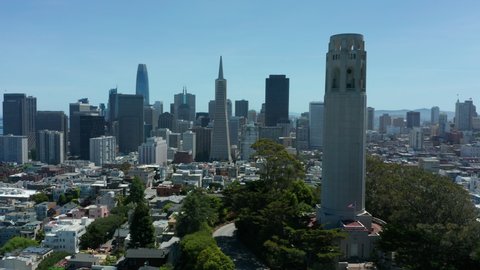 flying counter clockwise around Coit Tower with San Francisco passing in background