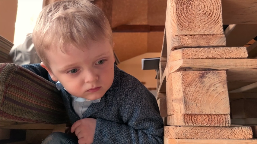 Curious little boy looks under the table