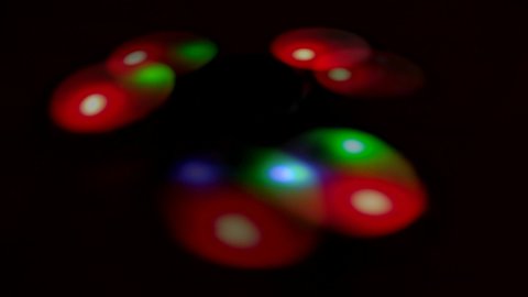Abstract blurred multicolored glare from the backlight of a rotating spinner. Spinning spinner with LED light.
