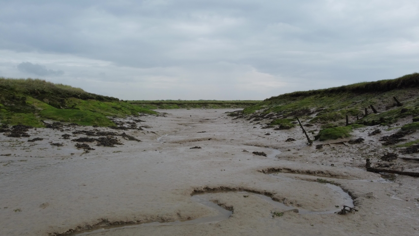 Muddy british marshland and creek