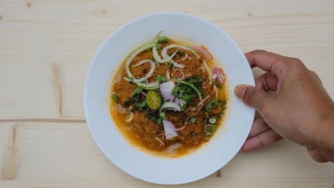 A footage of "Laksa Johor" been serve on the table during Eid Mubarak. Laksa Johor is spaghettis serve wish fish gravy coconut and spices soup.  
