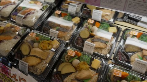 Culver City, CA USA - May 5 2021: This panning video shows a consumer display of prepared, ready-to-eat bento food boxes. 