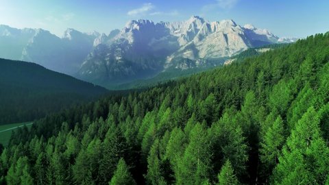 Aerial flight adove high mountain forest. Exploring Alps, Dolomites, Italy