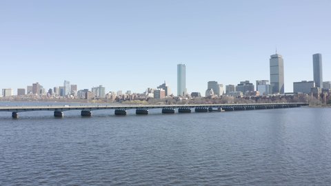 Traffic crossing Harvard Bridge against Boston skyline. Aerial forward