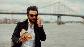 Busy Businessman Lunch Eating Sandwich And Talking On Phone.Manager Hurry To Work.Eat Snack In Taking Break Time.Cheerful Businessman Having Lunch Break Outdoor.Employee Eating Junk Food Sandwich Food - Powered by Shutterstock - Get 15% off with code: PIKWIZARD15