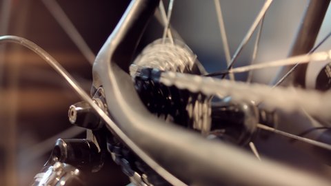 Cyclist On Bicycle Drivetrain System And Chain Rotating.Gear System 
And Bike Wheel.Cycling Drivetrain Chain Cassette And Spokes.Cyclist Pedaling Bike Endurance Exercising. Cycling Bike Wheel Rotation