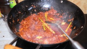 Video footage of beef rendang; a Malay cuisine being cooked.