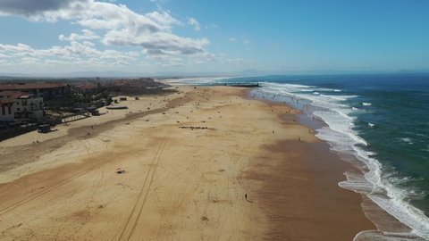 Hossegor south beach in Nouvelle Aquitaine France with bathers and surfers, Aerial flyover shot
