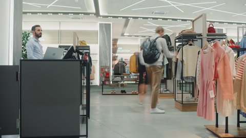 Time-Lapse in Clothing Store. Diverse Group of Costumers bying Clothes and Merchandise at Checkout Cashier Counter. Retail Fashion Shop Assistant Services Clients, Selling Designer Brands to People