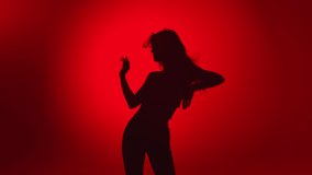 Seductive woman dancer shadow demonstrate dance movement isolated on red gradient studio background. Young flexible lady with perfect body dancing slow motion. Shot with RED camera in 4K - Powered by Shutterstock - Get 15% off with code: PIKWIZARD15