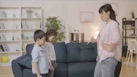 Upset young asian mother punishing two naughty kids, child upbringing problems