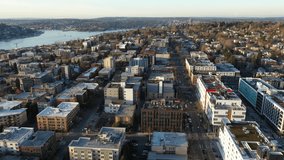 Cinematic aerial drone panning shot of Cascade, South Lake, Lake Union, Capitol Hill, Pike Pine, First Hill, Central Seattle, downtown at sunset in King County, Washington