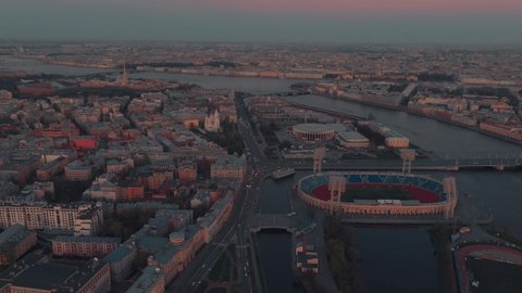 The Russian Venice, Aerial footage of center of Saint Petersburg, Russia at evening, Flight over the river and drawbridges at sunset, cityscape in dusk