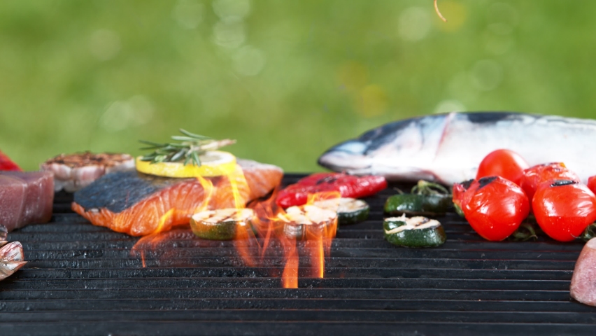 Super slow motion of falling shrimps and octopus tentacle on grill grid. Filmed on high speed camera, 1000 fps