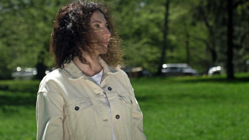 Teenage girl gives her mother a large beautiful bouquet of tulips. Mother hugs daughter. Mothers Day.