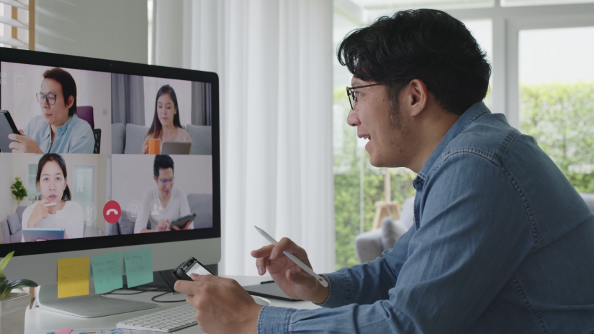 Business man talking about sale report in video conference.Asian team using computer and tablet online meeting in video call.Working from home, Working remotely and Self isolation at home - Powered by Shutterstock - Get 15% off with code: PIKWIZARD15