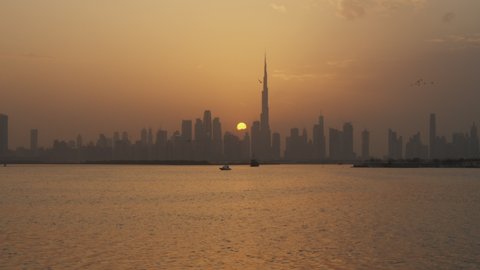 Dubai city skyline during sunset. Tall skyscrapers in Dubai cityscape in the warm evening light in Dubai, UAE in 2021
