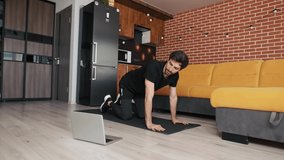 Man doing push up at home live master class via laptop