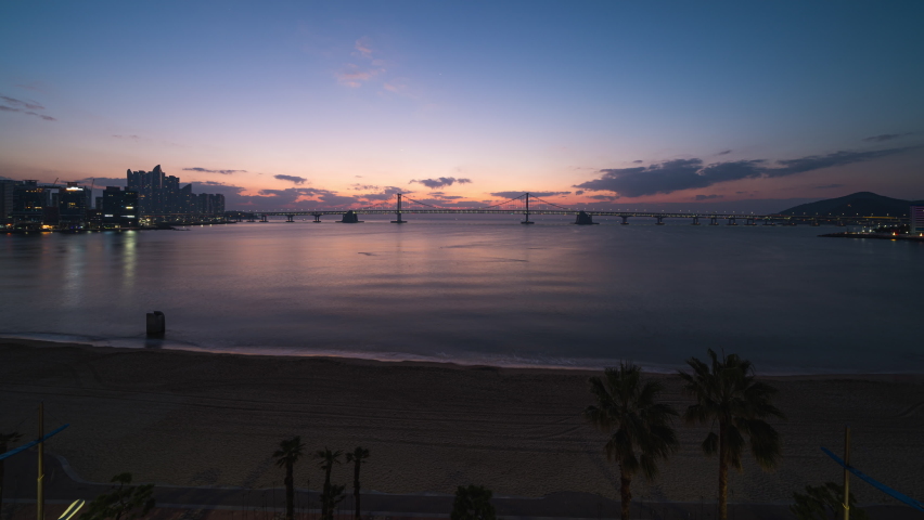 Zoom in Timelapse 4K sunrise skyline of Busan city as viewed from across the sea popular Destinations in Busan,South Korea
