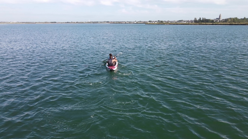 young couple canoeing on the Traict, Le Croisic, Brittany, France, close to the entrance of the salt march of Guerande