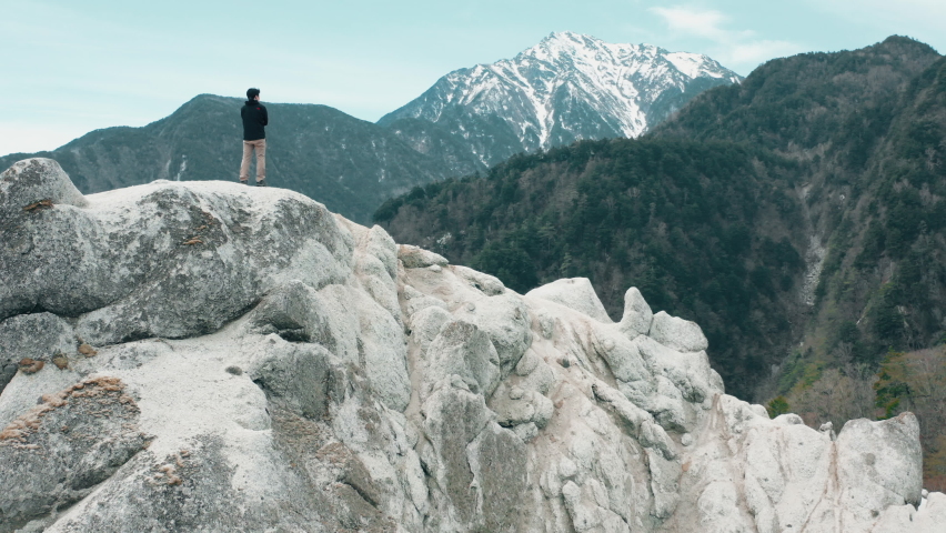 
The flight above the man on beautiful mountain