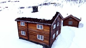 Traditional large classic log cabin in the mountains on a snowy cold winters day. 4K Aerial fly over. - Powered by Shutterstock - Get 15% off with code: PIKWIZARD15