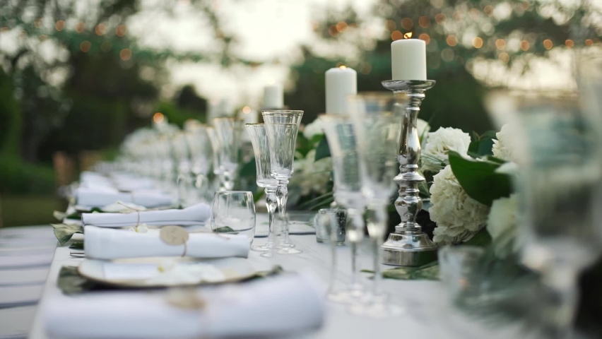 Wedding decor bouquet candle dinner. tablecloth catering, celebration, dining room, festive, fire, flower, glasses, light, merry Christmas, party, reception, romantic, setting. copy space 2022. | Shutterstock HD Video #1072489076