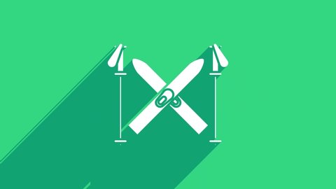 White Ski and sticks icon isolated on green background. Extreme sport. Skiing equipment. Winter sports icon. 4K Video motion graphic animation.