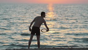 Slow motion of a fit man playing frisbee on the beach. Vacation concept - Powered by Shutterstock - Get 15% off with code: PIKWIZARD15