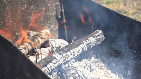 Burning wood in the grill. Burning Birch logs in a Metal Grill. Preparation of Coals for Frying Meat