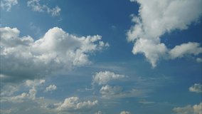 Time-lapse of the floating clouds on a sunny blue sky. Cumulus formation scene in a fast movement motion landscape. Bright heaven background. High-quality 4K footage video.