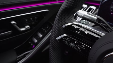 Close-up view of car interior. View of steering wheel of car control music. Expensive and rich interior of representative car.