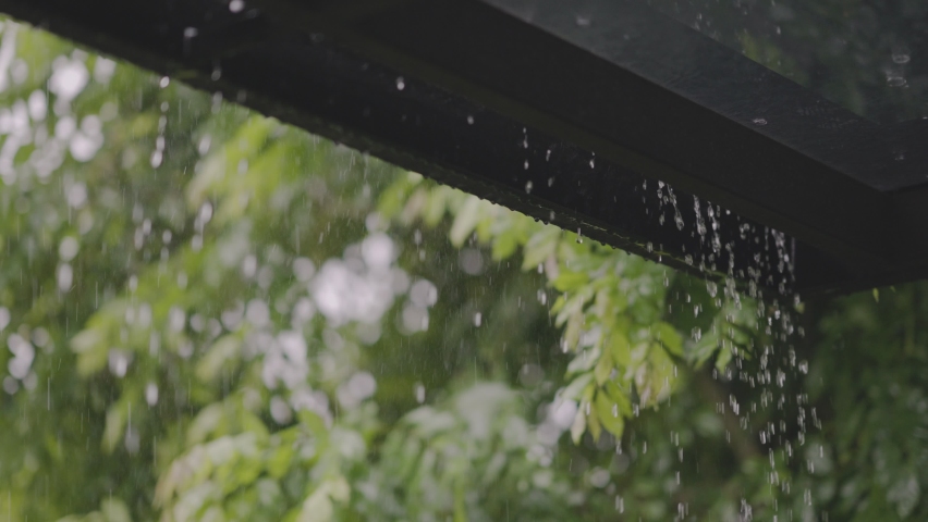 Rain water dropping from roof in day time. Raining in motion. Slow motion. Royalty-Free Stock Footage #1072509794